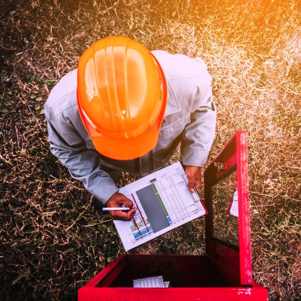 safety officer working on checking Fire extinguisher at outdoor plant